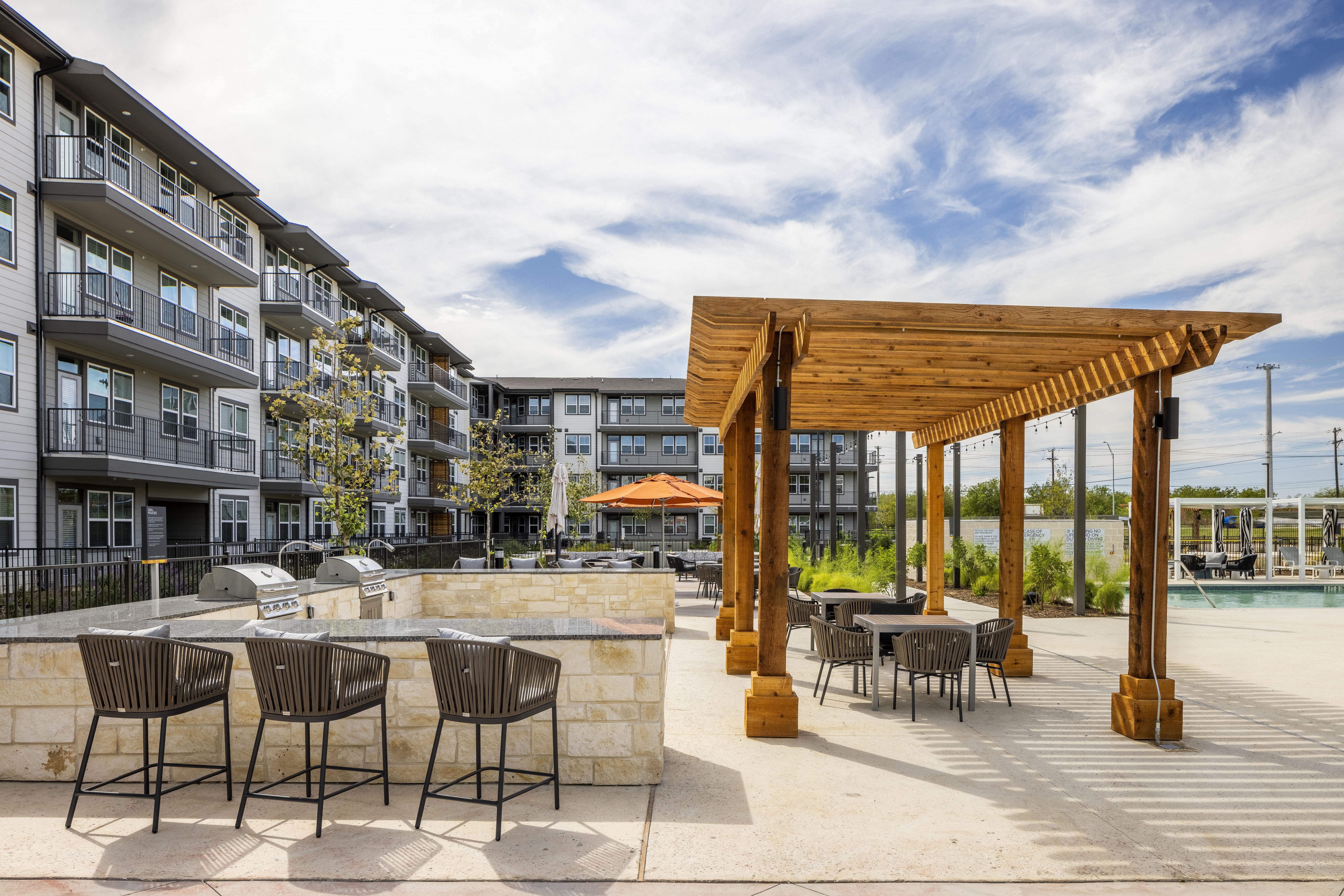 an outdoor patio with tables and chairs and